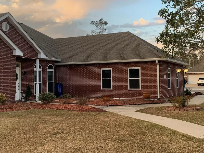 angled front view brick home gutter system