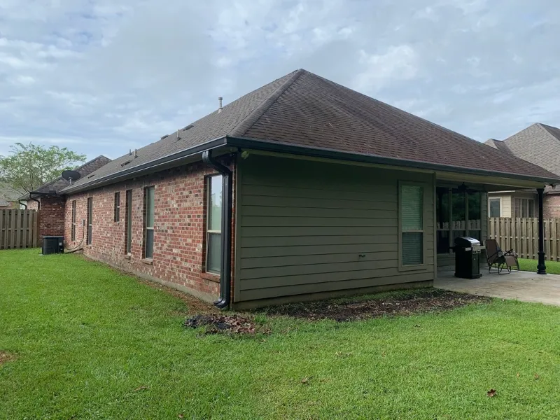 black downspout red and green siding backyard baton rouge