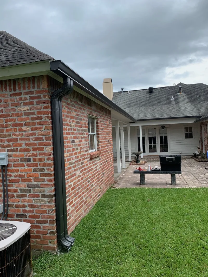 black downspout red brick courtyard installation baton rouge