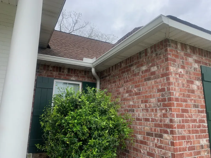brick corner white gutters home gonzales performance patios and gutters