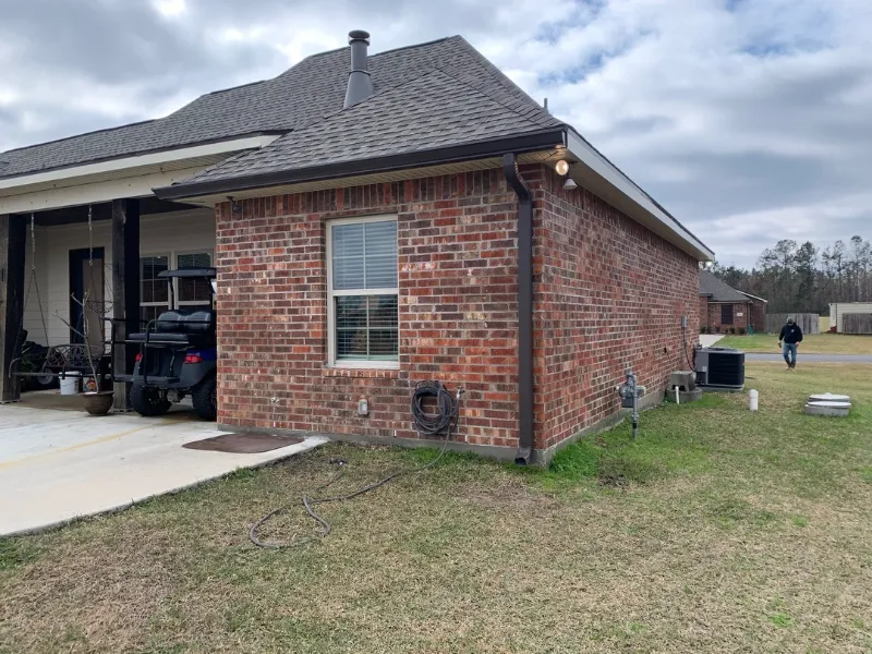 brick house brown gutters side yard walker project performance patios and gutters