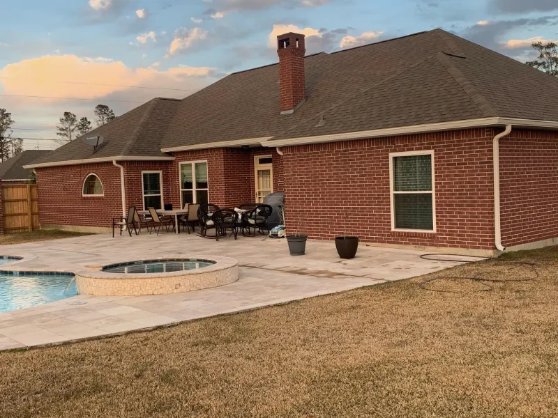 brick house with hot tub and gutters