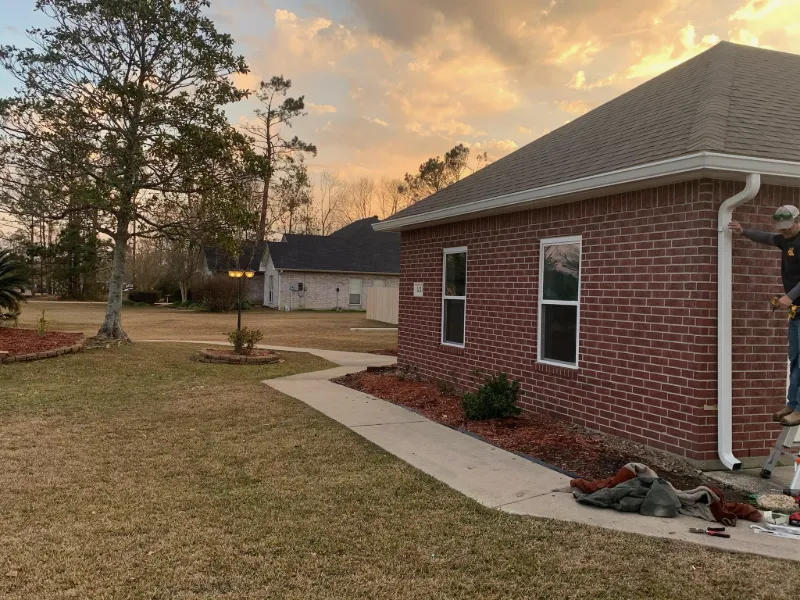corner view brick home gutter installation