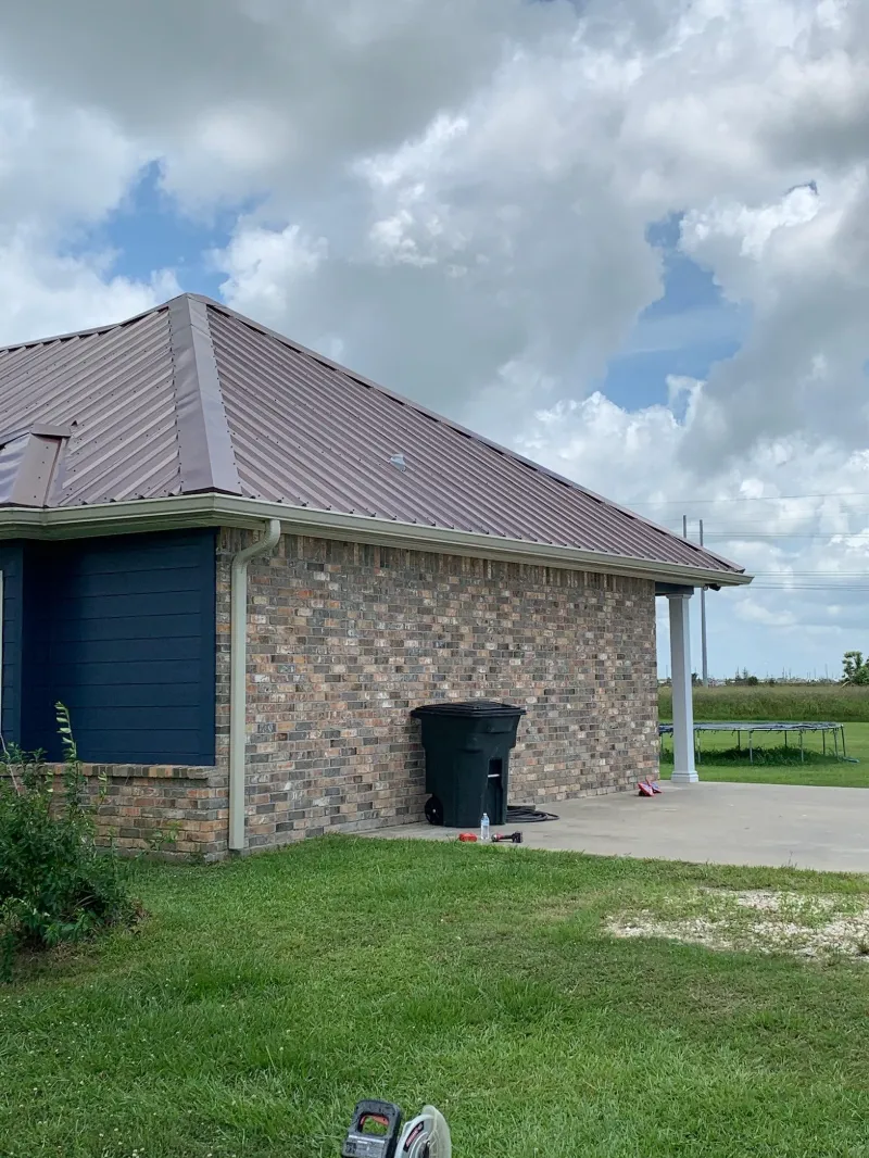 dark blue home metal roof driveway view