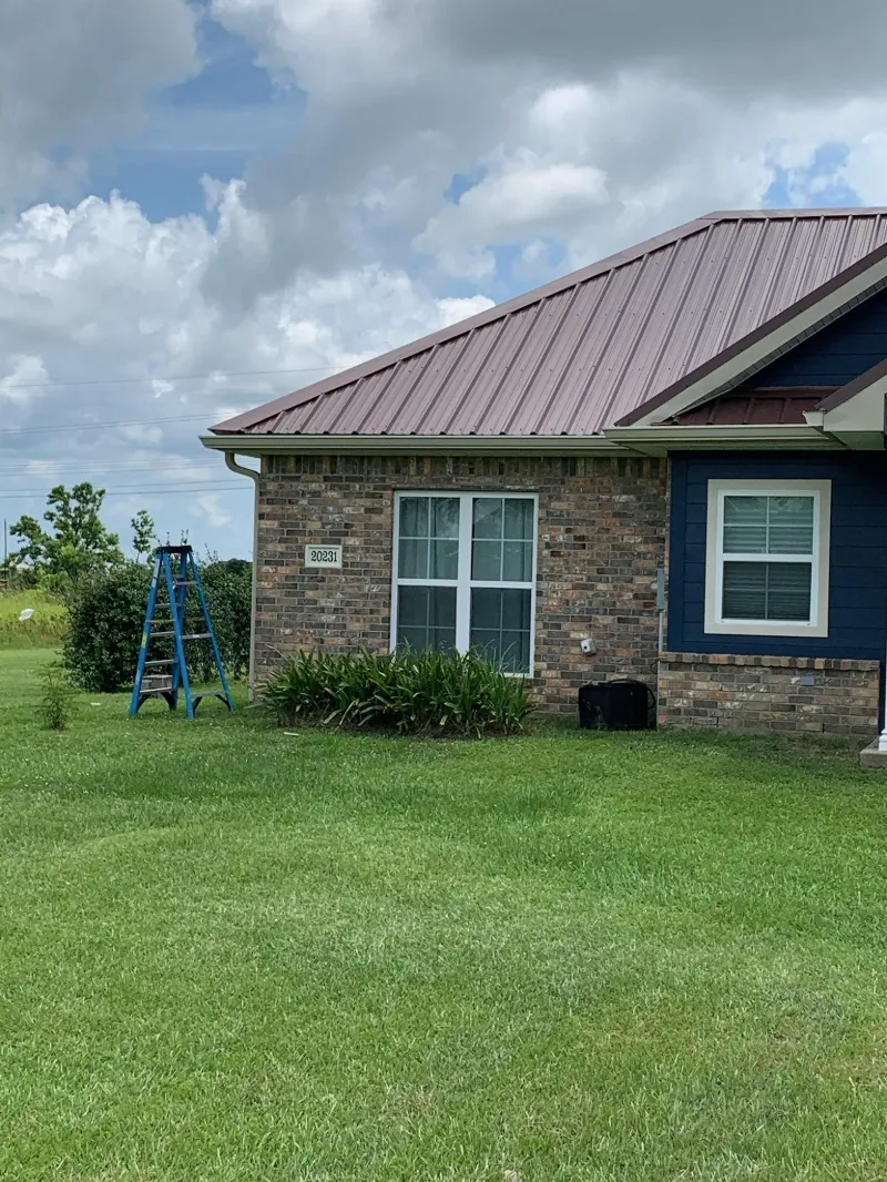 dark blue home metal roof front window view
