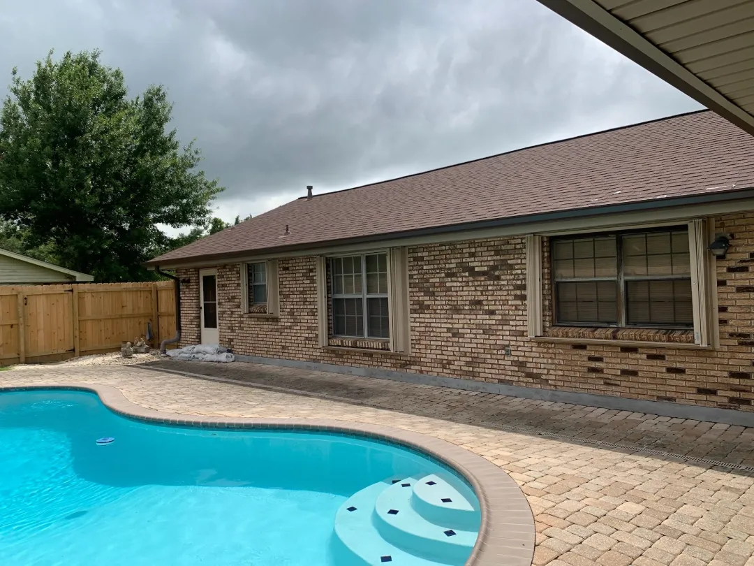 dark brown gutters brick house poolside performance patios