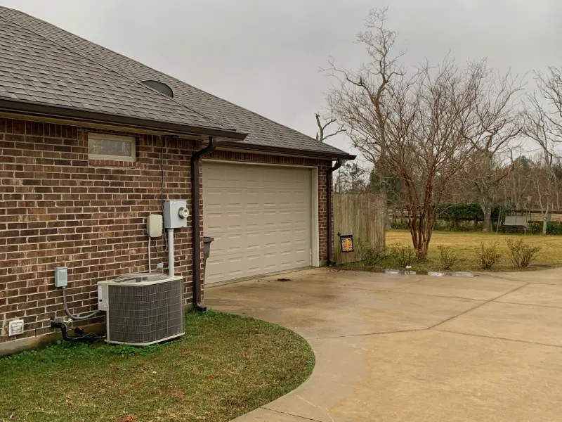 dark gutter system on red brick home near garage 1