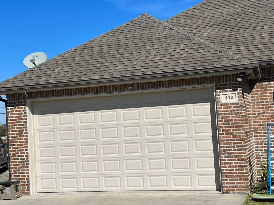 dark gutters above white garage door denham springs