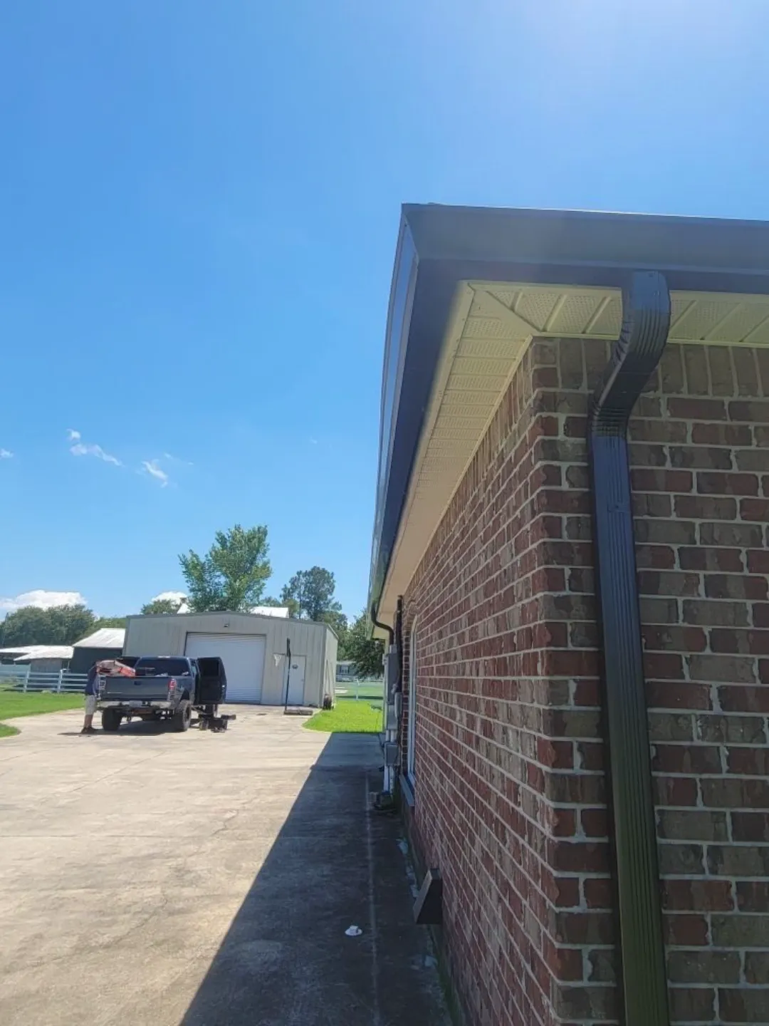 dark gutters downspout brick building walker