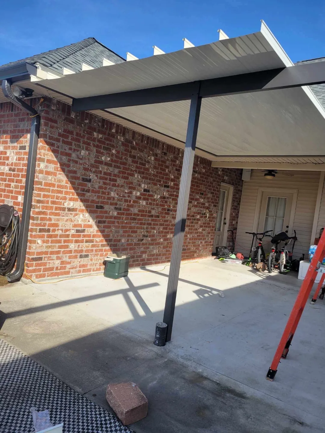 downspout and gutter installation on brown brick home in baton rouge