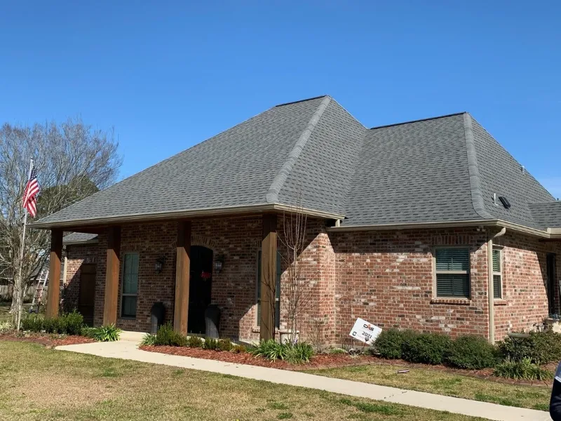 front right corner of brick house with large roofl