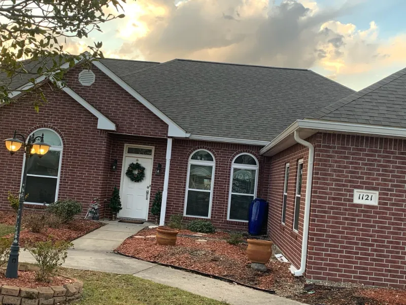 front view brick house gutters installed