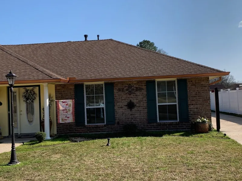 front view brown shingle roof green shutters