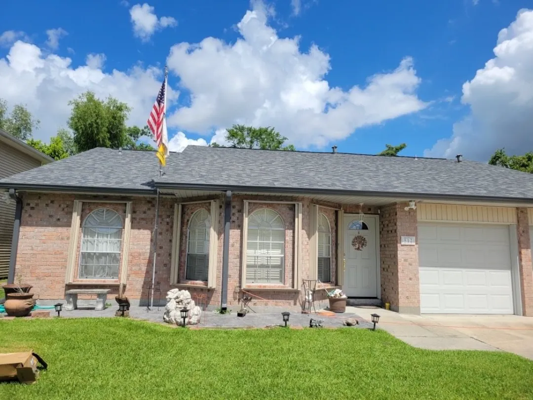 grey gutters brick house american flag plaquemine