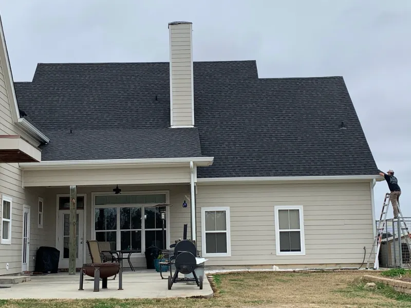 gutter installation on beige home with covered patio 1