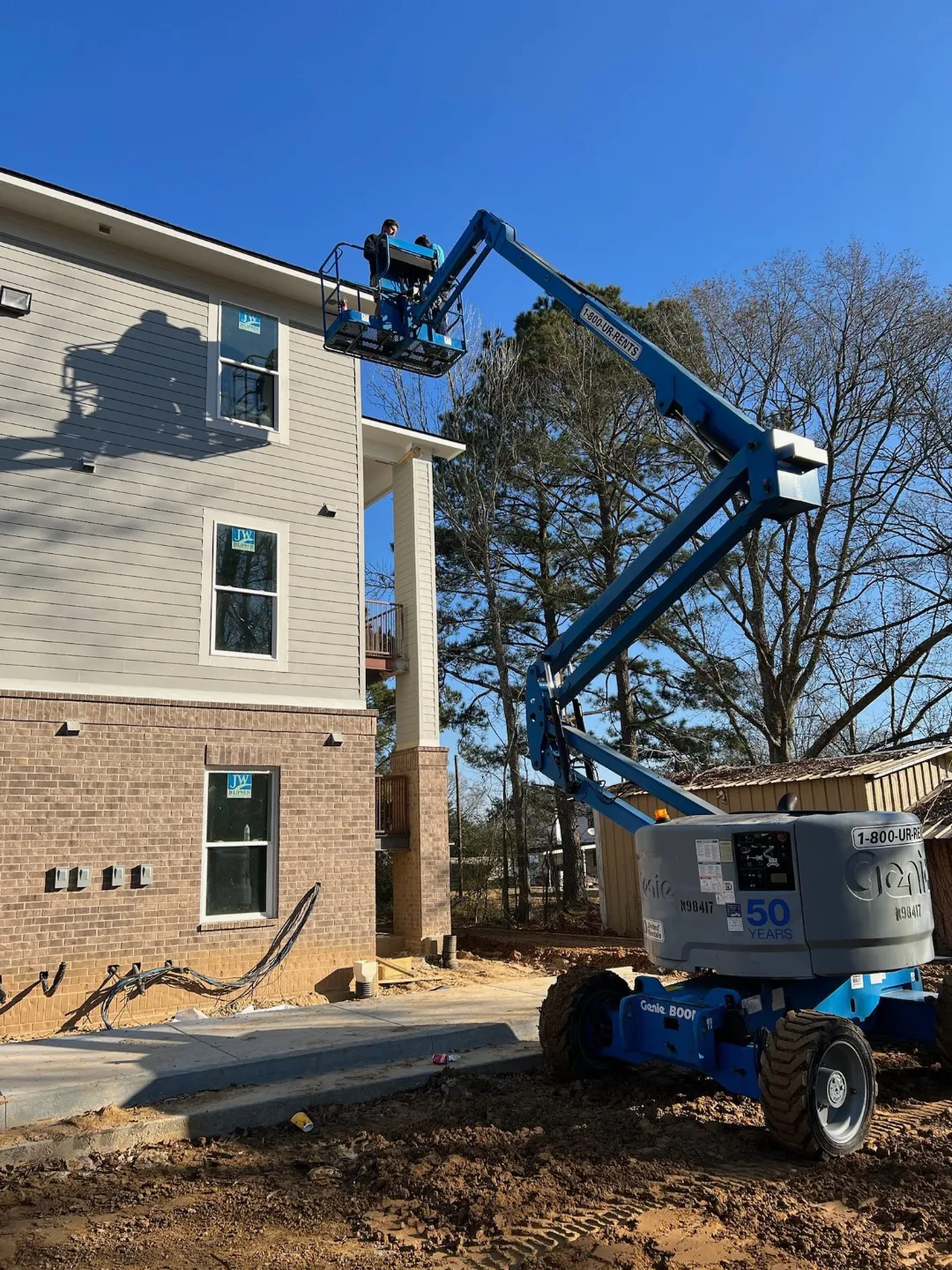 gutter work from boom lift apartment building baton rouge