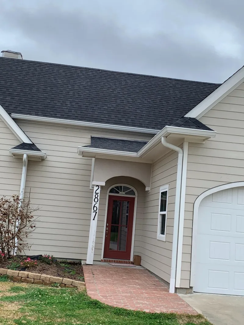 house with curved windows and gutters