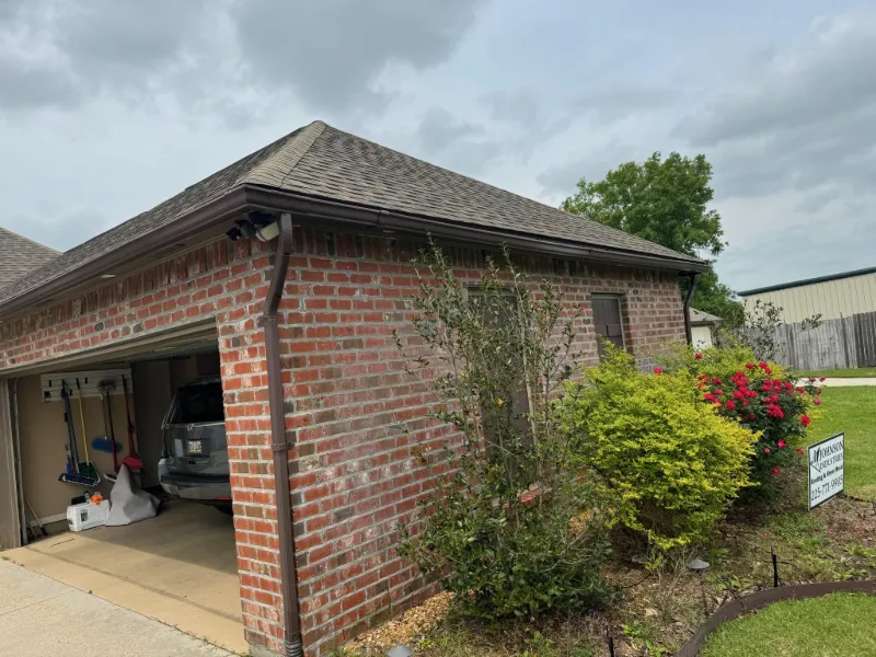 light brick home side view gutters installed