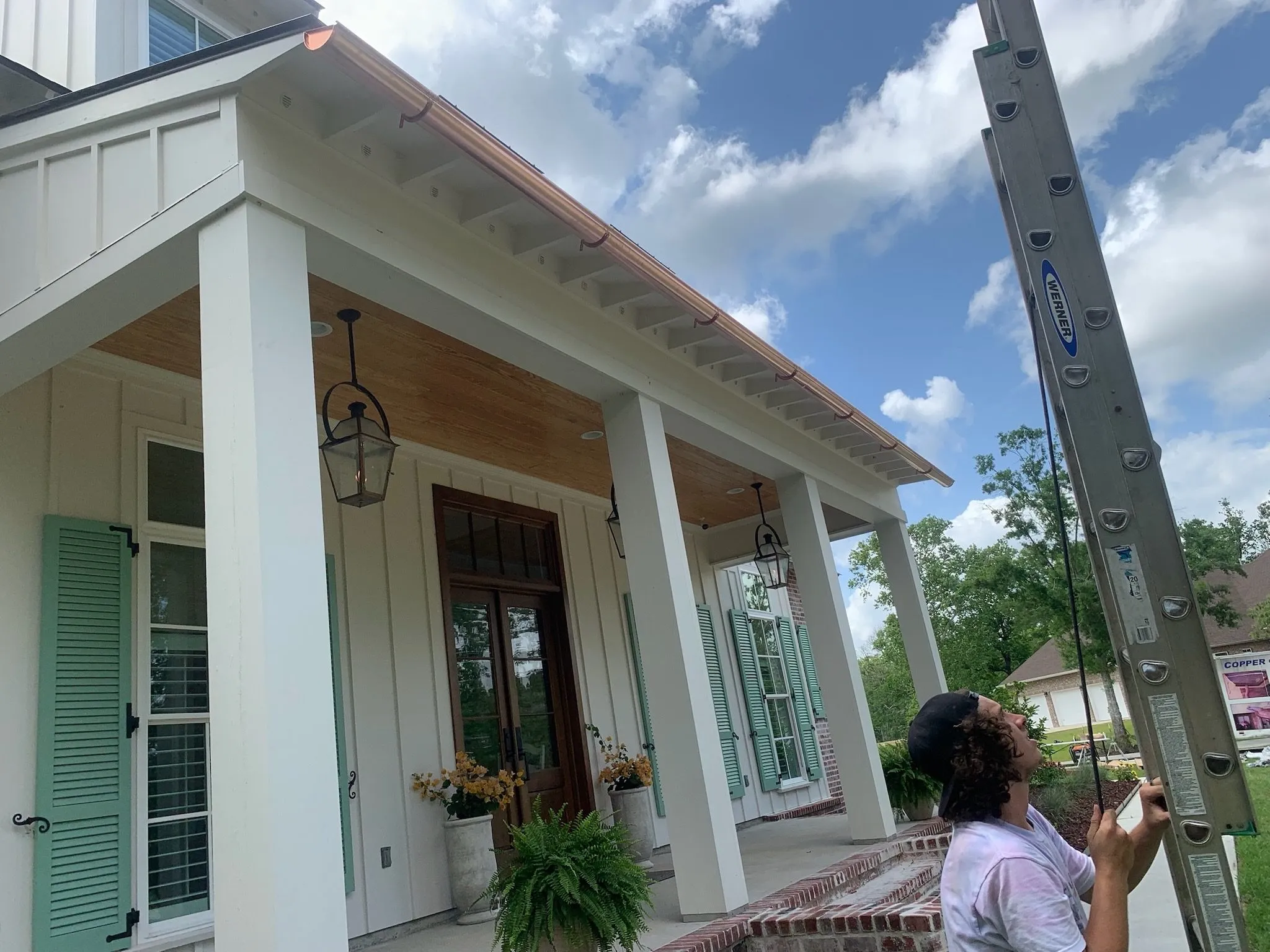 light colored house copper gutters worker prairieville la