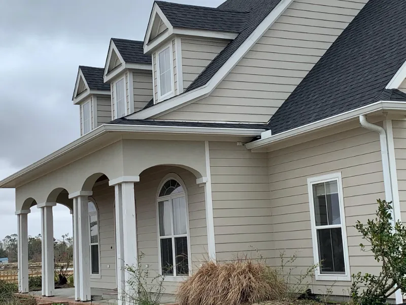 modern tan house with white gutters