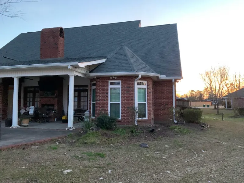 rear brick building wall with white door and gutters baton rouge