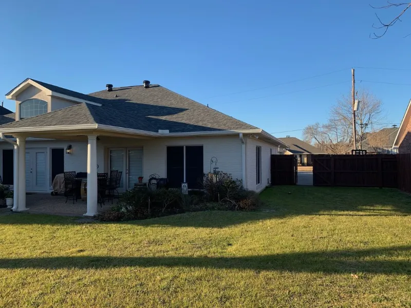 red brick home side gate white gutters