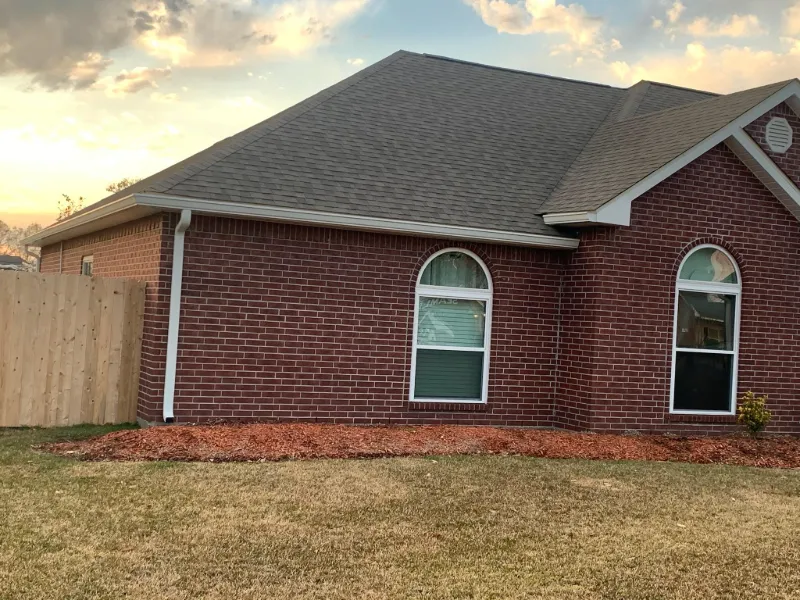 side view brick home with arched windows