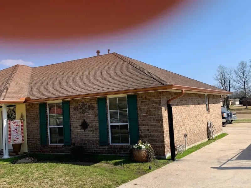 side view brown shingle roof copper gutters