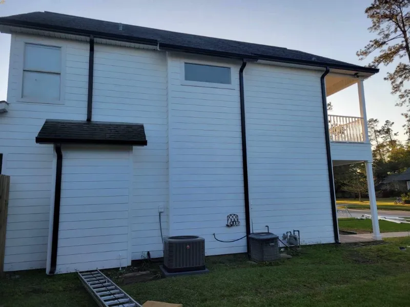 siding and gutters on white home in baton rouge