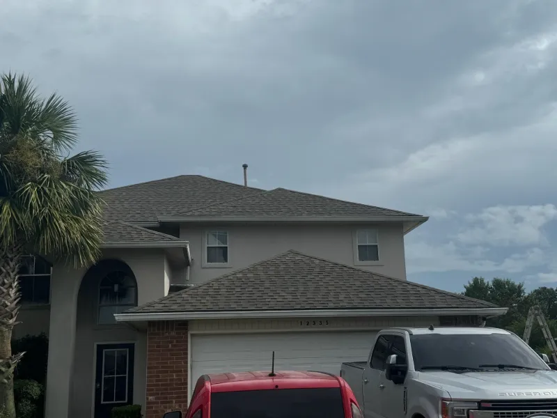 stucco home gutters complete view under sky