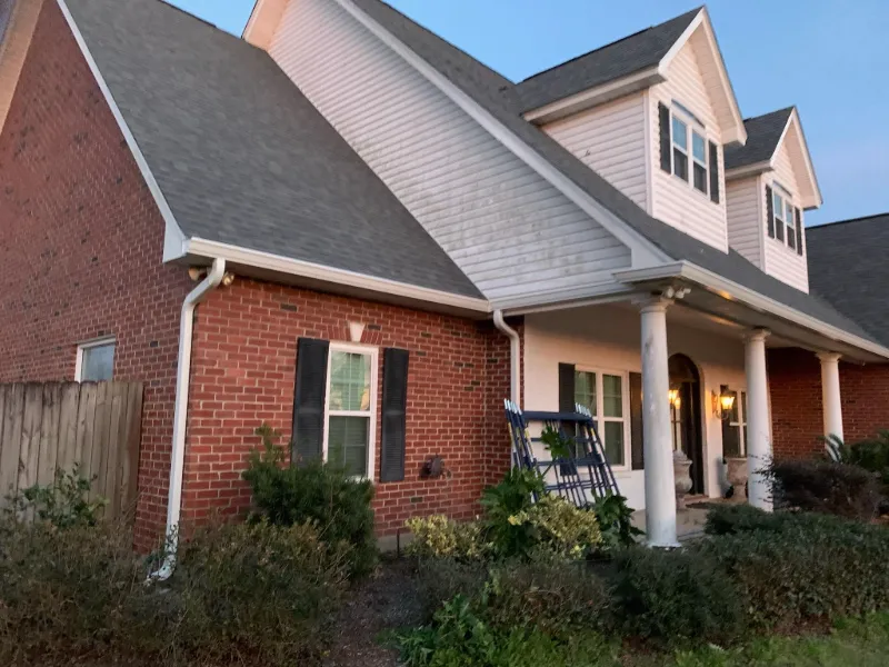 technician working on gutter next to ladder baton rouge
