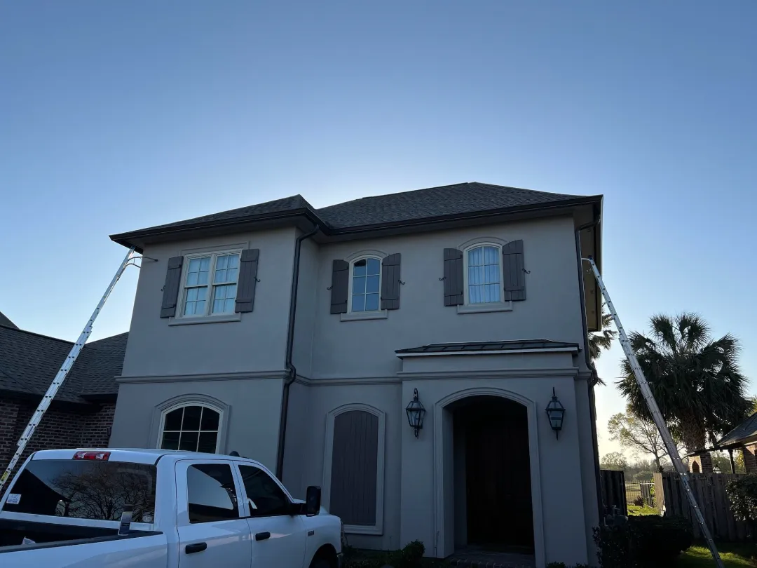 two story stucco house two ladders gonzales la