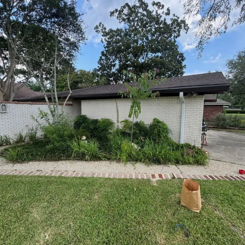 white brick home with garden and gutters in baton rouge