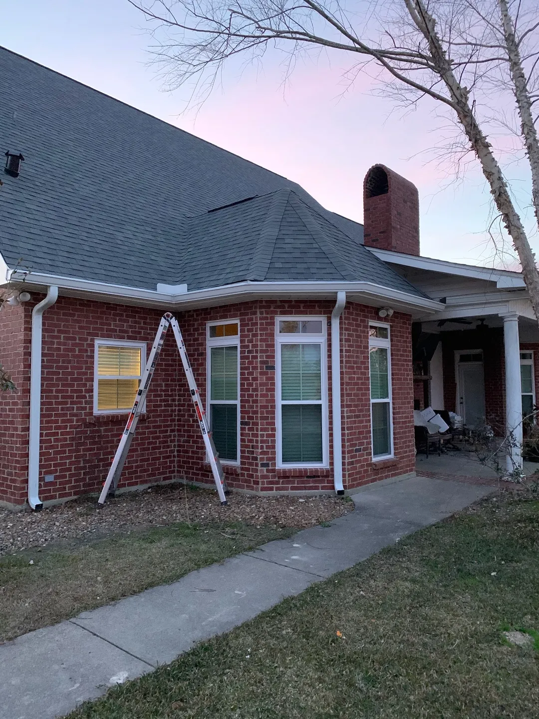 white gutter corner installation near bay window