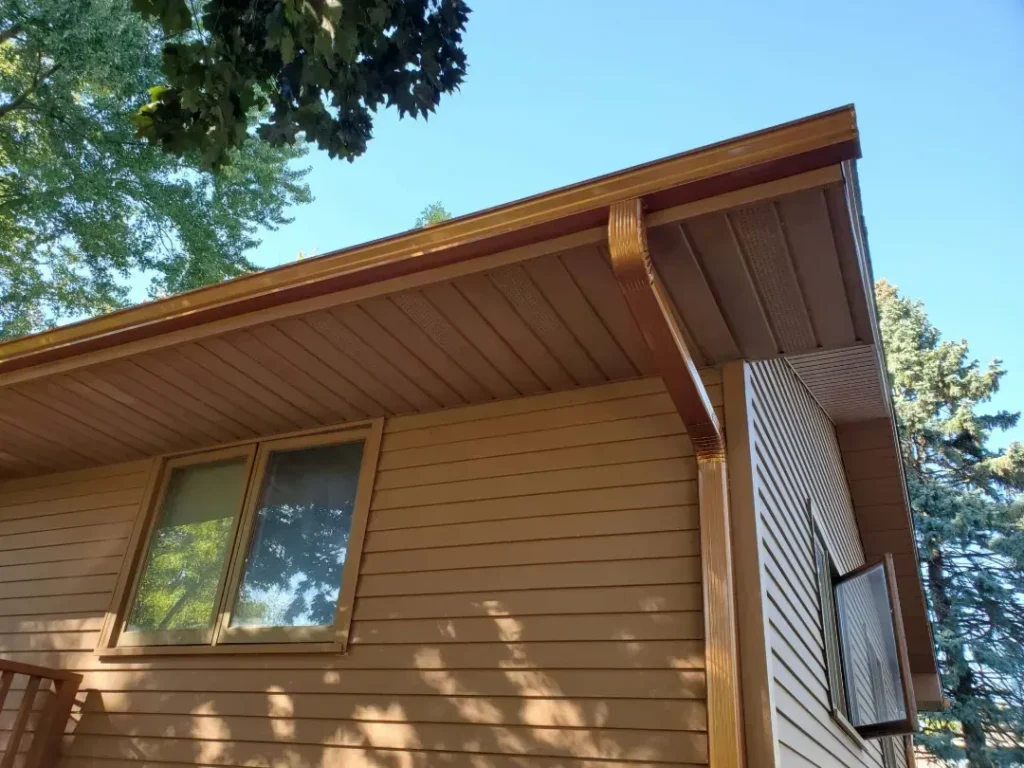 close up brown gutter downspout installation