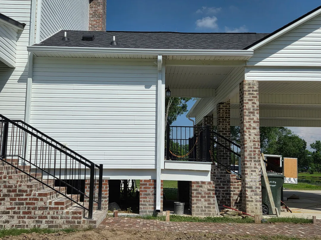 elevated white home black railing seamless gutters performance patios and gutters