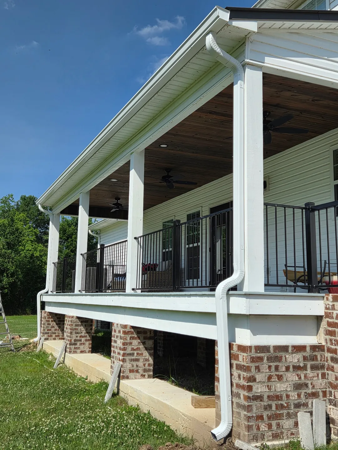 porch railing seamless gutters brick pillars performance patios and gutters